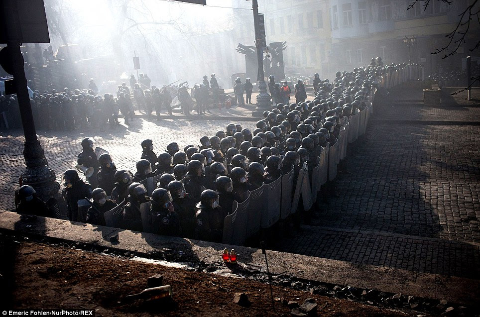 Massed forces: Anti-government protesters clash with riot police in Kiev