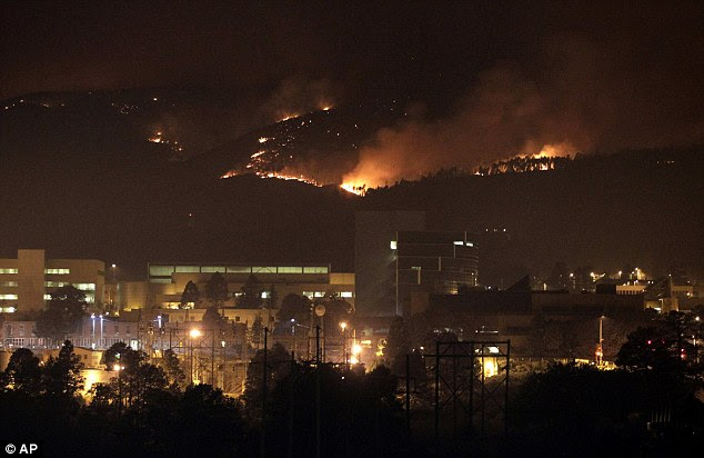 Too close for comfort: The wildfire burns near Los Alamos Laboratory, a nuclear facility, driving thousands of people from their homes