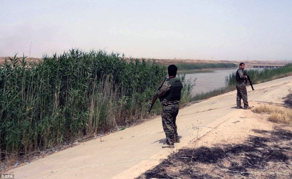 Kurdistan's Peshmerga soldiers secure an area in Kirkuk city - the move was a victory for them as they have fought over the land for years