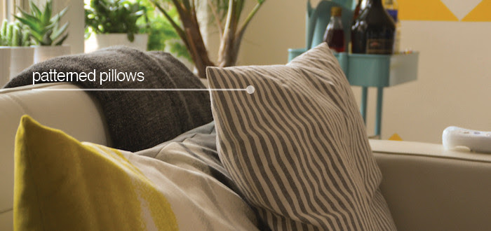 ikea post, couch pillow tableau, mixing pillow patterns, gray striped pillow, white leather couch, living room