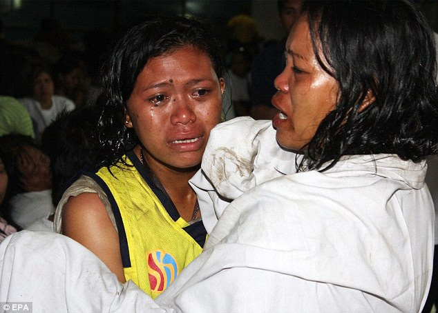 Tears: Rescued Filipino survivors arrive at a port in Cebu city, central Philippines