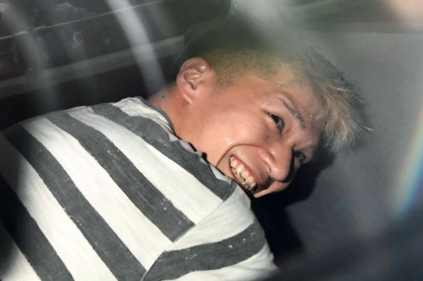 Satoshi Uematsu, suspected of a deadly attack at a facility for the disabled, is seen inside a police car as he is taken to prosecutors, at Tsukui police station in Sagamihara, Kanagawa prefecture, Japan