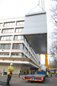 A crane lifts the modules directly from the lorry to the courtyard site