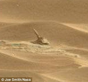 Nasa has been beaming photos from Mars since its Curiosity rover landed there in August 2012, and this latest discovery (pictured) was spotted by amateur astronomer Joe Smith, 45, from Bristol. Mr Smith said: 'I think it looks like a gun - as in an artillery piece - but it's way too small for that really'