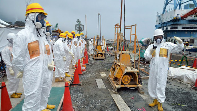 This photo taken on August 6, 2013 shows local government officials and nuclear experts inspecting a construction site to prevent the seepage of contamination water into the sea, at Tokyo Electric Power's (TEPCO) Fukushima Dai-ichi nuclear plant in Okuma, Fukushima prefecture. (AFP Photo / Jiji Press)
