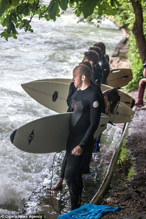Line-up: Surfer wait for the hectic river break to clear for their turn