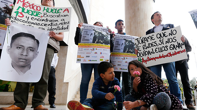 Students holding placards take part in a protest in support of the 43 missing students of the Ayotzinapa teachers' training college Raul Isidro Burgos, outside the Mexican Embassy in Bogota November 7, 2014 (Reuters / John Vizcaino)