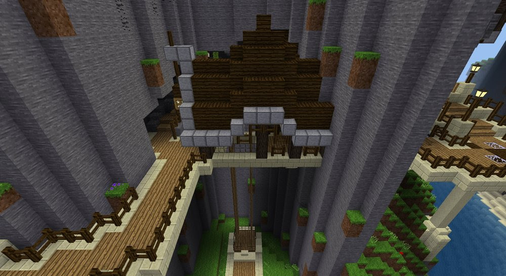 A short, wooden bridge with a very pronounced hump in its roof, spans between cliff walls.