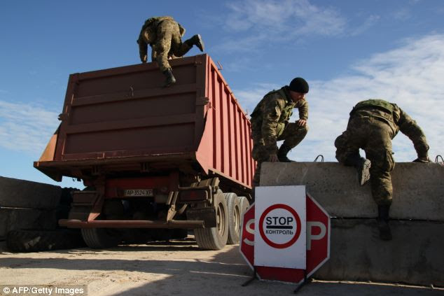 Ukrainian border guards search a truck at a check point on the administrative border of Crimea and Ukraine