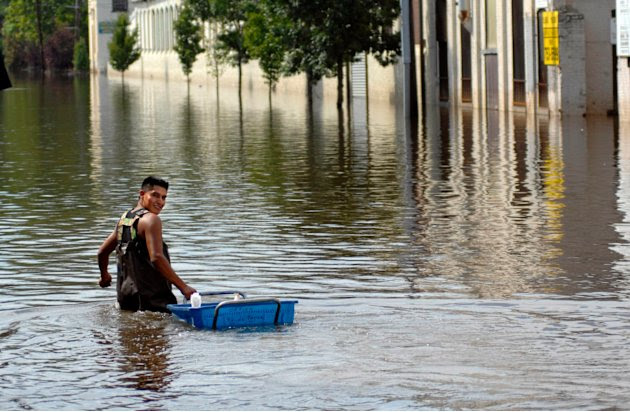 A worker retrieves items from a factory in the flood waters of the Passaic River days after the passing of Hurricane Irene in Paterson