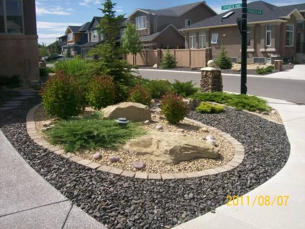 Driveway landscaping for a corner lot done with xeriscaping. This home ...