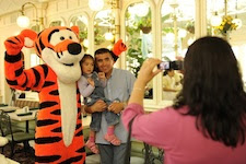  Chilean miner rescuer Patricio Alejandro Sepulveda Munoz (right) joins his daughter Esperanza Anais Sepulveda (left, age 2) and Disney character Tigger as his wife, Yessica Vivian Sepulveda (foreground) takes a souvenir photograph at Walt Disney World Resort