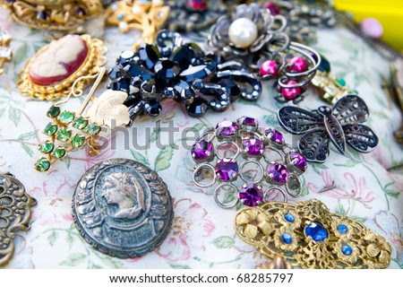 Vintage jewelry at the flea market (focus is on purple one, shallow ...
