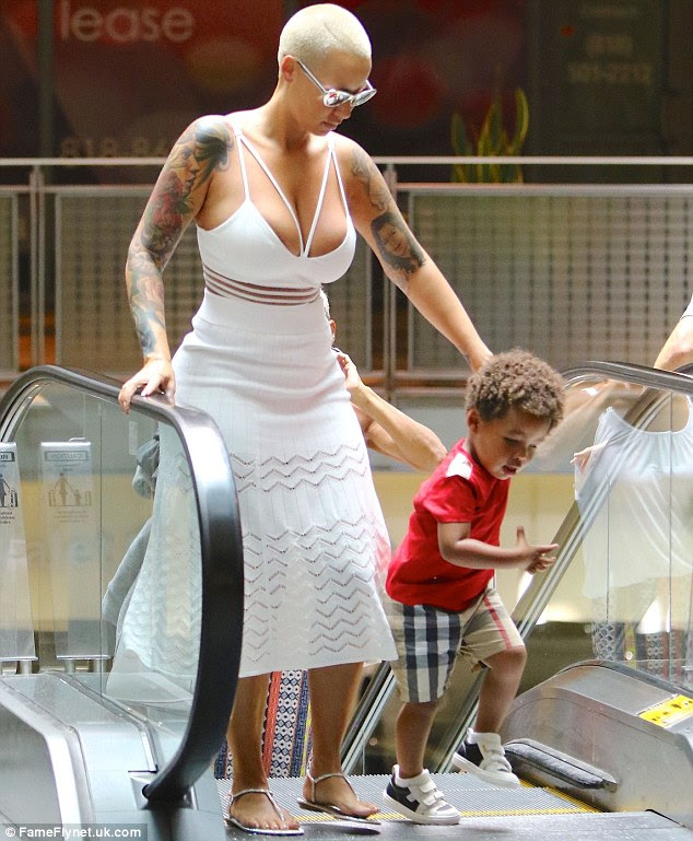 Eye popping: Amber showed off plenty of cleavage in a summery white dress 