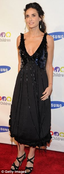 Fading away? Demi appeared tiny in her Louis Vuitton black dress with sequinned and feathered embellishment