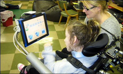 Child with cerebral palsy with a classroom assistant