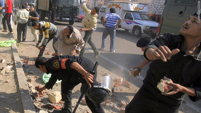 Egyptian police throw back stones at Christian demonstrators during clashes over a new Coptic church in Cairo.