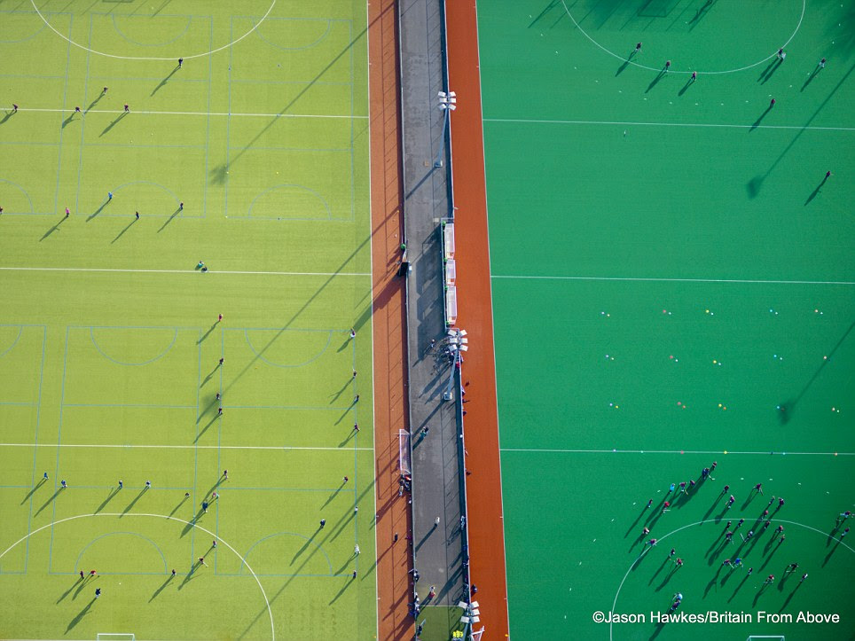 Jolly hockey pics: Pictured from above these
                    sports and the ant like people pitches take on a
                    strange geometrical beauty 