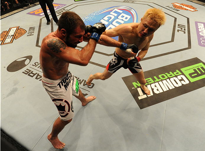 BALTIMORE, MD - APRIL 26:  (R-L) Takanori Gomi punches Isaac Vallie-Flagg in their lightweight bout during the UFC 172 event at the Baltimore Arena on April 26, 2014 in Baltimore, Maryland. (Photo by Patrick Smith/Zuffa LLC/Zuffa LLC via Getty Images)