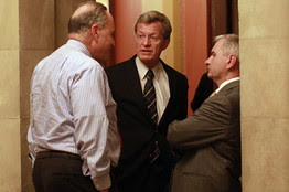 [Sen. Charles Schumer, left, Sen. Max Baucus and Sen. Jack Reed take a short break during ongoing negotiations on Capitol Hill on Saturday.]