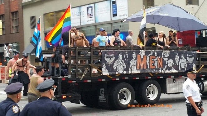 Homosexual Sadomasochistic "Pride" - Brought to You by Walmart: This float for the New York city homosexual "leather" bar The Eagle rolls down Fifth Avenue at the New York City "Pride" parade Sunday. Note the black-and-blue flag at left symbolizing "leather pride"--the S&M counterpart to the rainbow-colored flag symbolizing "gay pride." Sadistic/masochistic "leather" sex involves extreme behaviors that glorify domination, brutality and human degradation. This includes "master-slave" couplings in which one partner becomes the "sex slave" of another "master." Homosexual leathermen revel in some of the vilest practices invented by mankind, including hand-arm-rectal "fisting." Click to enlarge. Note the police looking on at lower left: one wonders what they are thinking. Photos may be reproduced provided credit given as follows: "Photo: AmericansForTruth.org."