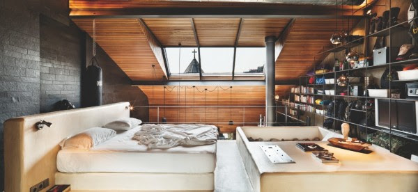 The lofted bedroom is simple and sunny.