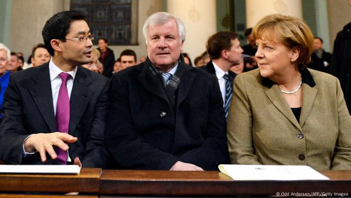 (Front row from L) German Interior Minister Hans-Peter Friedrich, German Economy Minister and vice-chancellor Philipp Roesler and Bavaria's State Premier Horst Seehofer and German Chancellor Angela Merkel attend a mass service to mark the resignation of Pope Benedict XVI at the St. Hedwig's Cathedral in Berlin on February 28, 2013. The mass coincides with the final hour of Benedict XVI papacy as his powers formally expire at 19:00 GMT. AFP PHOTO / ODD ANDERSEN (Photo credit should read ODD ANDERSEN/AFP/Getty Images) 