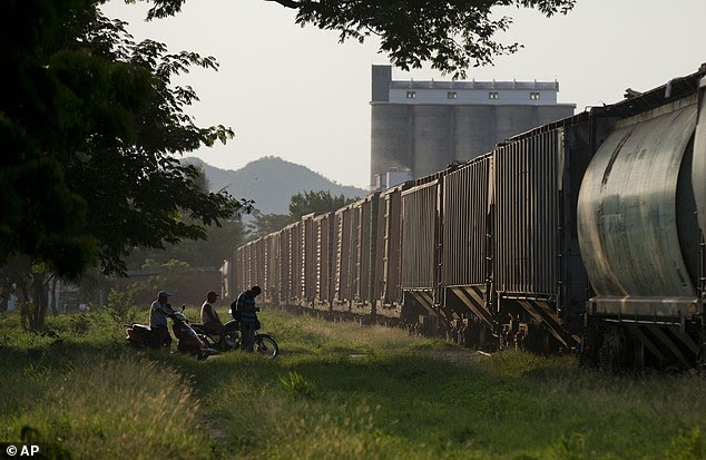 A northbound freight train, virtually empty of migrants, departs from Arriaga, Chiapas state, Mexico. In contrast to the many hundreds of migrants who used to board the train in Arriaga, only three could be seen jumping on on this day
