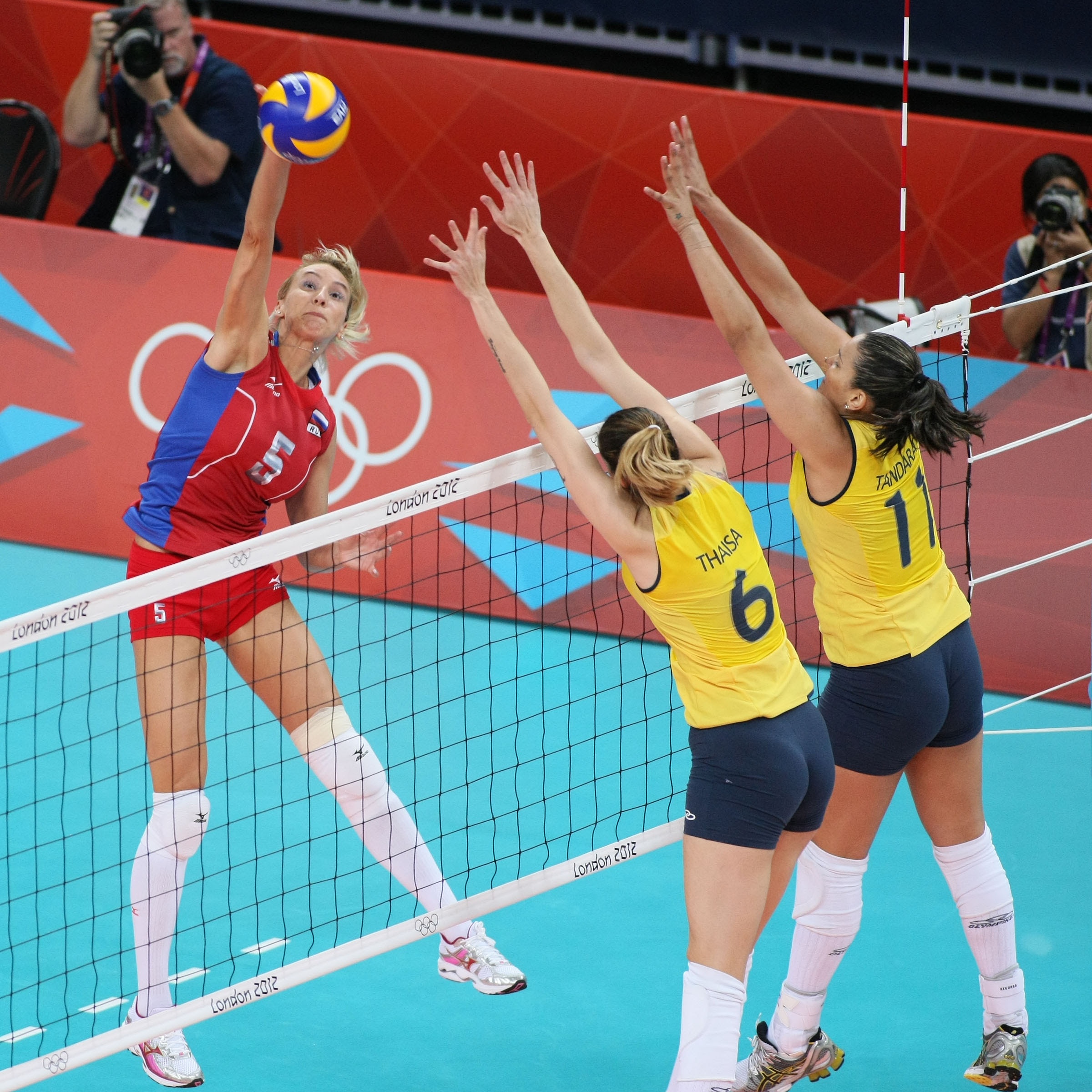 Liubov Shashkova (left) of Russia spikes against Thaisa ...