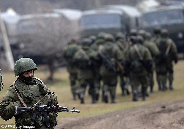 Out in force: Russian soldiers patrol the area surrounding the Ukrainian military unit in Perevalnoye, outside Simferopol, on Thursday