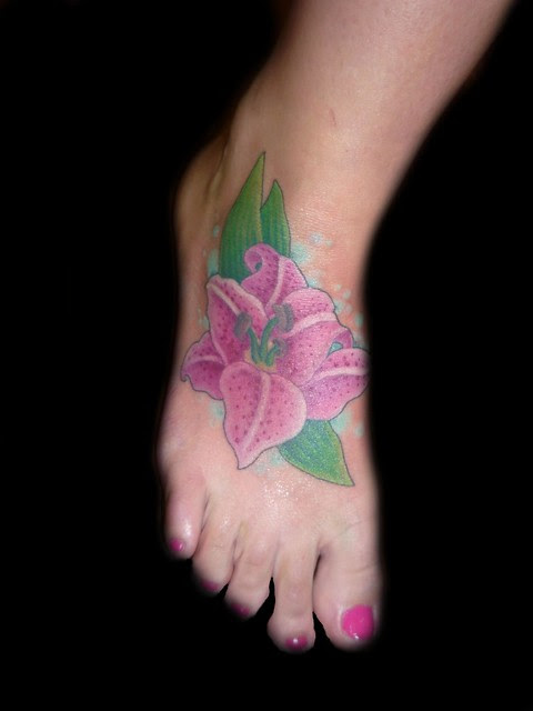 lilly flower tattoo on foot. This lilly tattoo was done by christina walker 