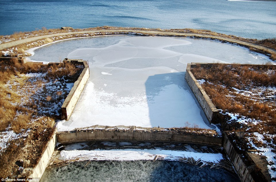 The unfinished base opens up to a larger body of water, and is mainly hidden in the cliffside of Pavlovsk, a town surrounded by volcanoes and cliffs 