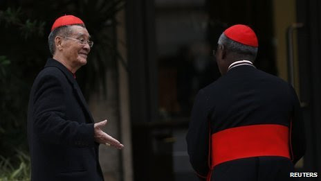 Vietnamese Cardinal Jean-Baptiste Pham Minh Man greets Cardinal Francis Arinze of Nigeria as they arrive for a meeting at the Vatican