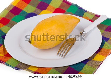 Yellow Mango In The Plate On Colored Table Linen With Fork Stock ...