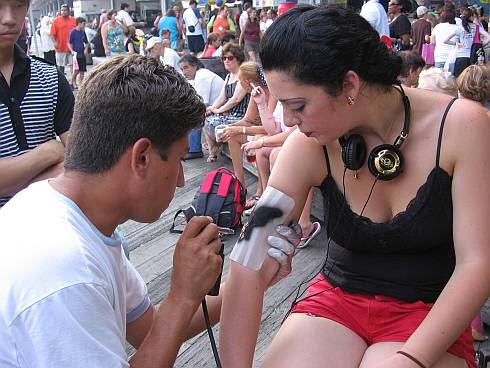 A girl getting an air-brush tattoo. At the appointed hour we hailed a cab to 