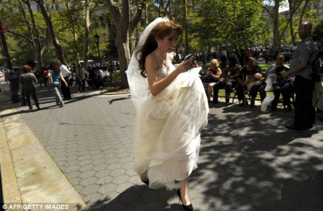 Bad timing: A bride in her wedding dress runs from the courthouse in Lower Manhattan in New York after feeling the terrifying shake
