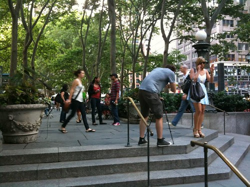 Man filming a woman for a video in Bryant Park