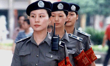 A team of police women patrol the street