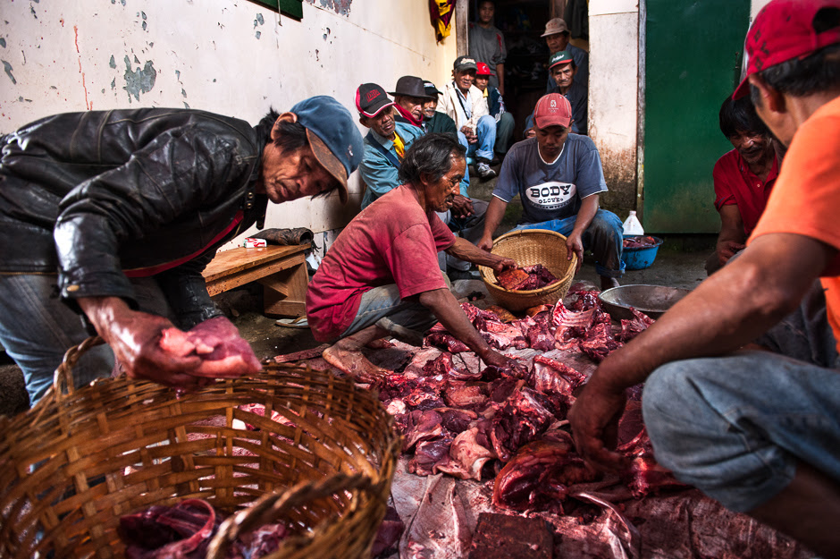 Men distributing meat