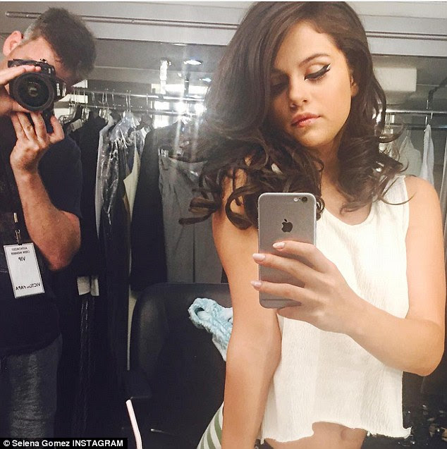 Belly-baring: On Tuesday, she took to Instagram with another sultry selfie taken in front of a mirror where she put her seamless black winged liner on full display