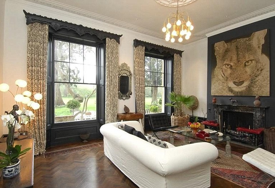 No expense spared: One of the main living areas in the multi-million pound house in Berkshire, which has grand open windows and traditional fireplaces