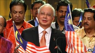 Malaysian Prime Minister Najib Razak (c) during a televised statement on security laws