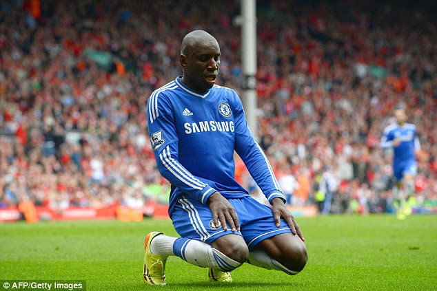 To the ground: Demba Ba celebrates traditionally after putting Chelsea ahead away at Liverpool