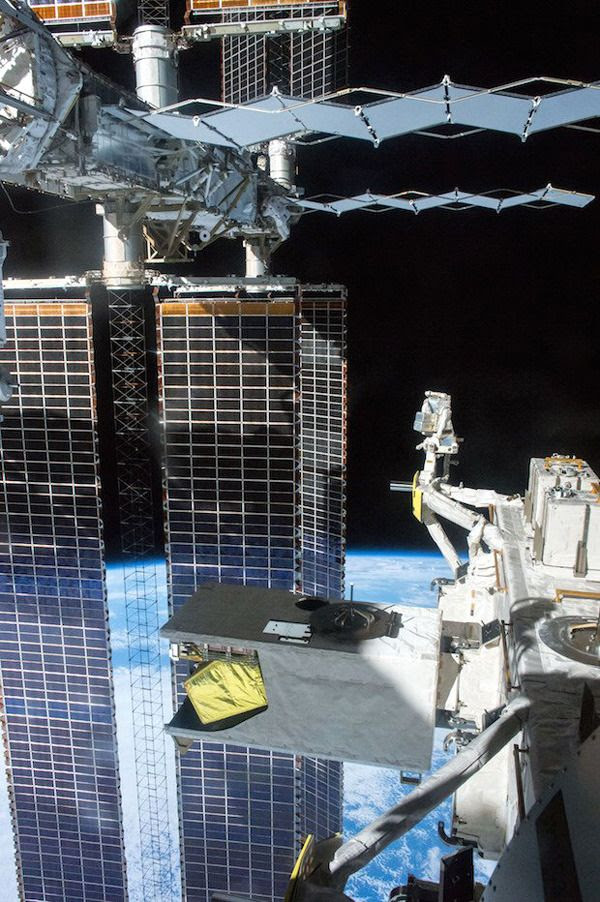 The original version of a photo showing a spacewalking astronaut working on the exterior of the International Space Station.
