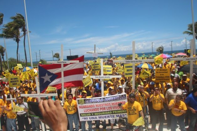 Electric utility workers of the UTIER labour union protest for safer workplace conditions. UTIER spearheads the fight against privatisation and against the Puerto Rico government's unpopular emergency economic measures. Courtesy of Photo Jam