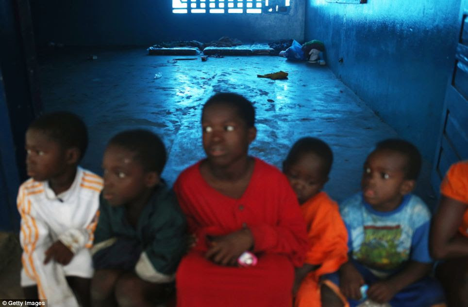 Children sit in the isolation ward as the disease continues to spread in West Africa