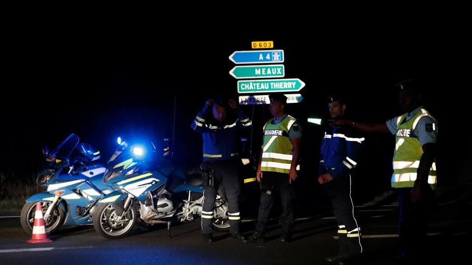 French gendarmes maintain a roadblock near the scene where a car ploughed into a pizzeria, killing a young girl and injuring several other people in Sept-Sorts.