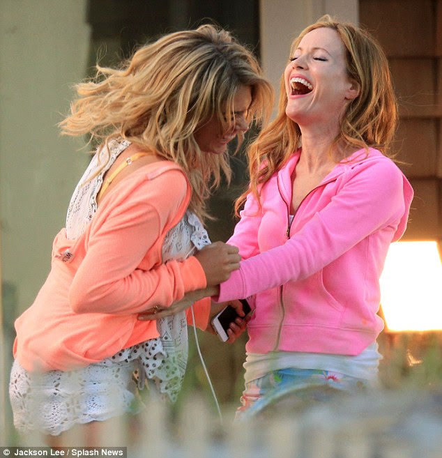 Hysterics: The women looked to be having a ball as they laughed huddled over with laughter together on set 