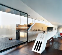 The awesomely unique angular counter is definitely a centerpiece in this narrow penthouse kitchen.