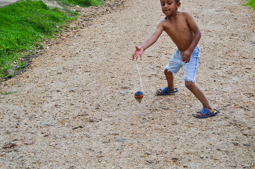 Boy showing tricks in spinning top game